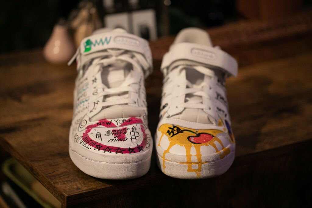 Boston' Chery's white shoes with hand-drawn art.