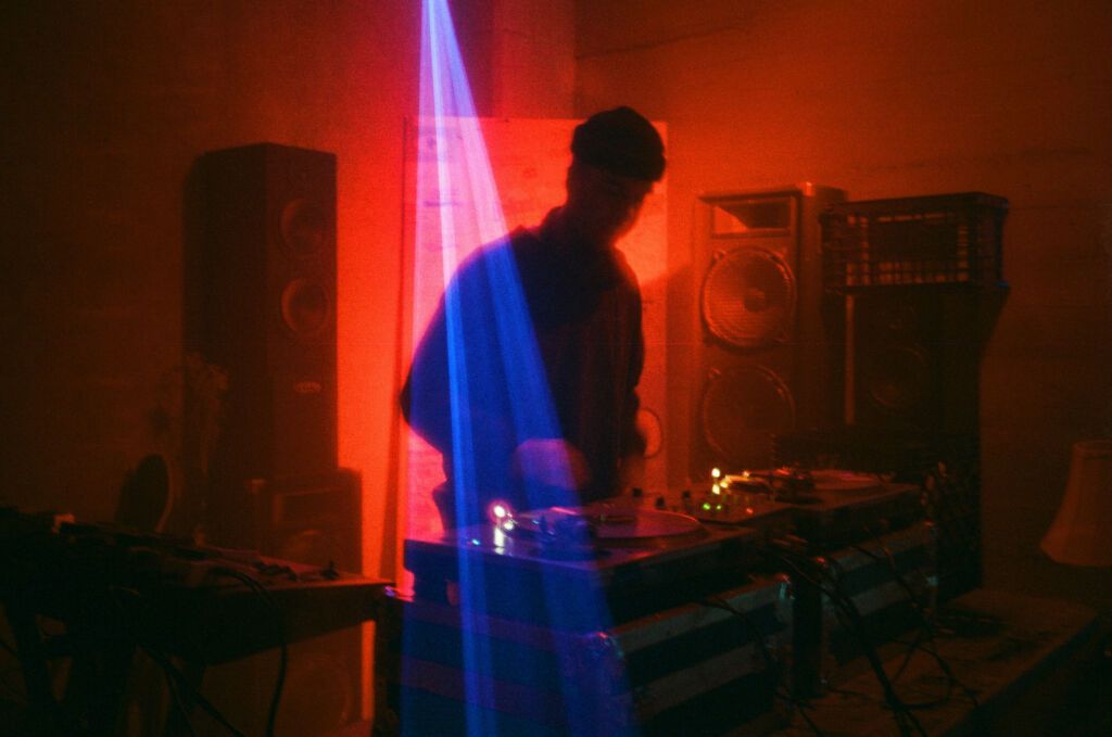 DJ at a turntable with visually stunning lighting
